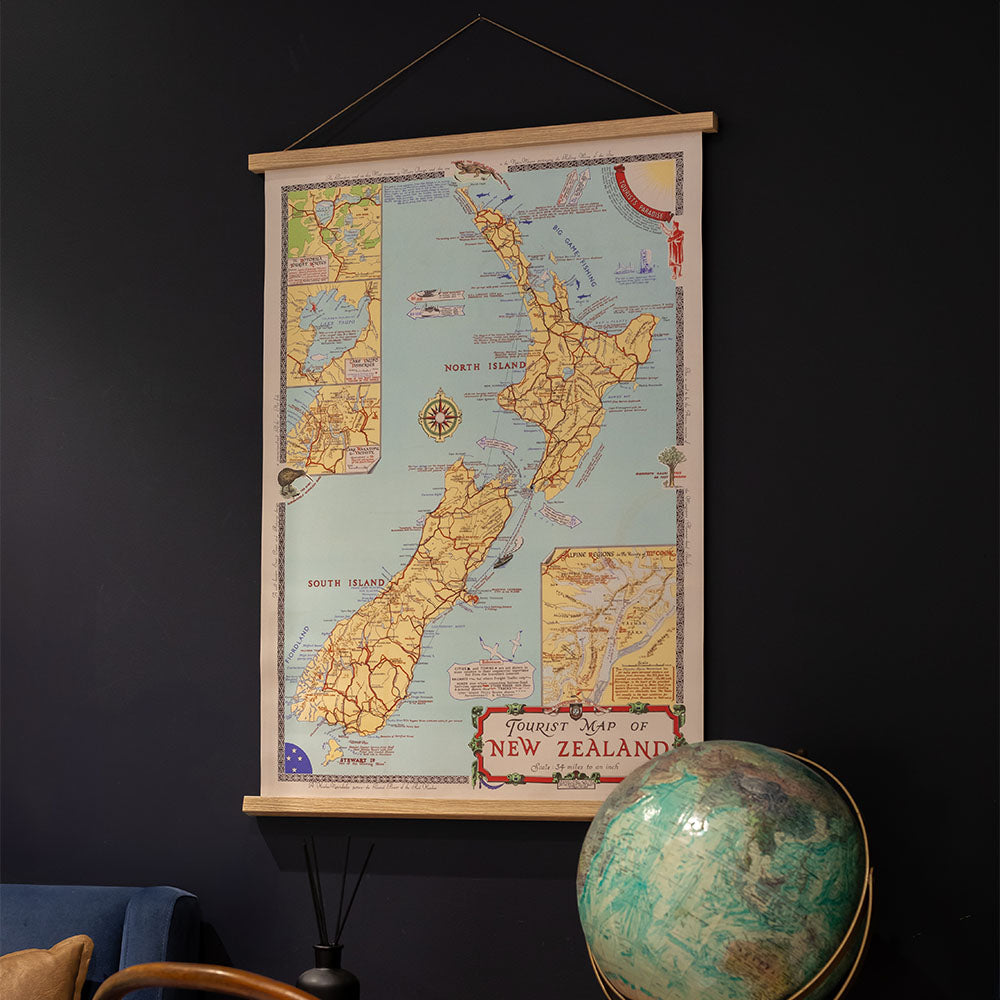 The New Zealand Tourist Map Wall Chart adds stylish decor to a dark wall. Ready to hang, this art is perfect for any travel lover’s space, featuring a globe and a chair in the corner for an adventurous touch.