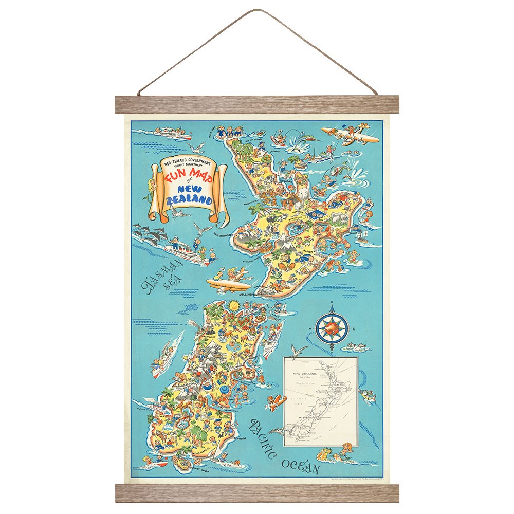 The 1950s Fun Map Map Wall Chart features a colorful, cartoon-illustrated vintage map of New Zealand highlighting local activities and landmarks, framed in wood with a hanging string. Includes an inset showing New Zealand’s location.