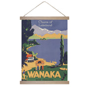 The Wanaka, Charm of Lakeland Wall Chart features a vintage design with Charm of Lakeland and WANAKA NEW ZEALAND text, showcasing a scenic lakeside landscape. Made in New Zealand, its ready to hang and perfect for home decor.