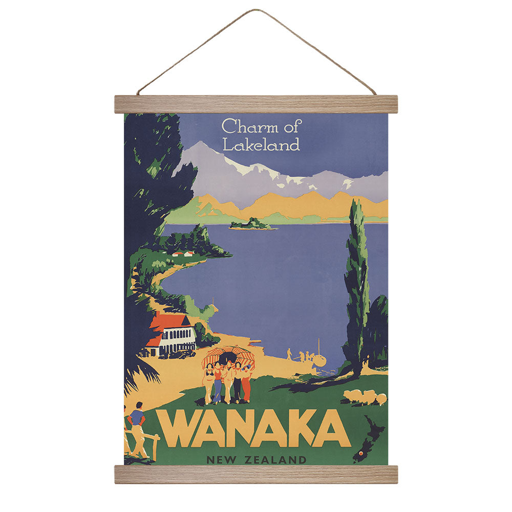 The Wanaka, Charm of Lakeland Wall Chart features a vintage design with Charm of Lakeland and WANAKA NEW ZEALAND text, showcasing a scenic lakeside landscape. Made in New Zealand, its ready to hang and perfect for home decor.