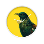 The Bright Tui Wooden Frame Clock – Second displays an iridescent-feathered Tui with a white throat tuft, set on a vivid yellow background.