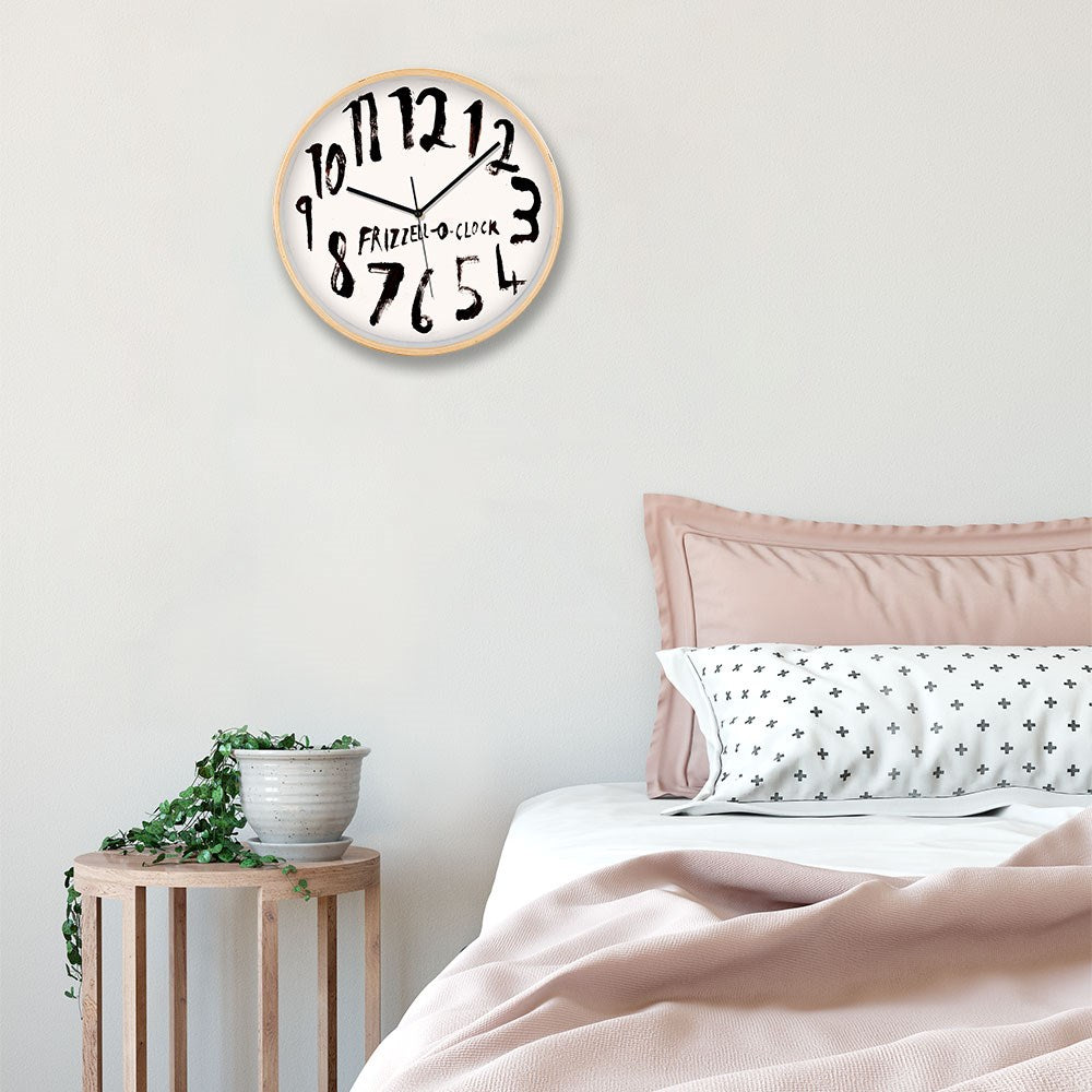 A bedroom with a neatly made bed in pink and white bedding, a small wooden side table holding a potted plant, and a Dick Frizzell - OClock White Face Wooden Framed Clock featuring silent movement and distorted numbers.