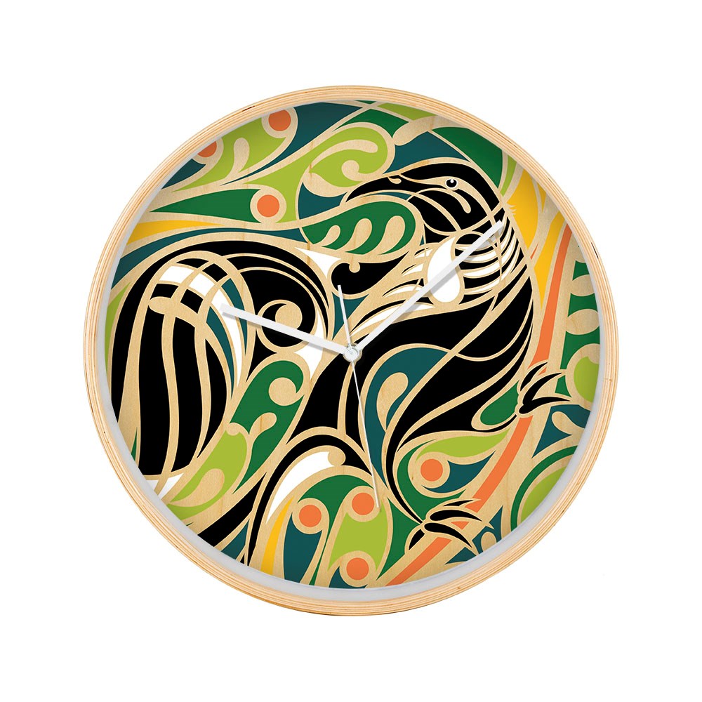 The Shane Hansen - Tui Wooden Frame Clock features a round wooden frame and a colorful abstract bird design in black, green, orange, and yellow. It has white hour and minute hands and a minimalist face without numbers.