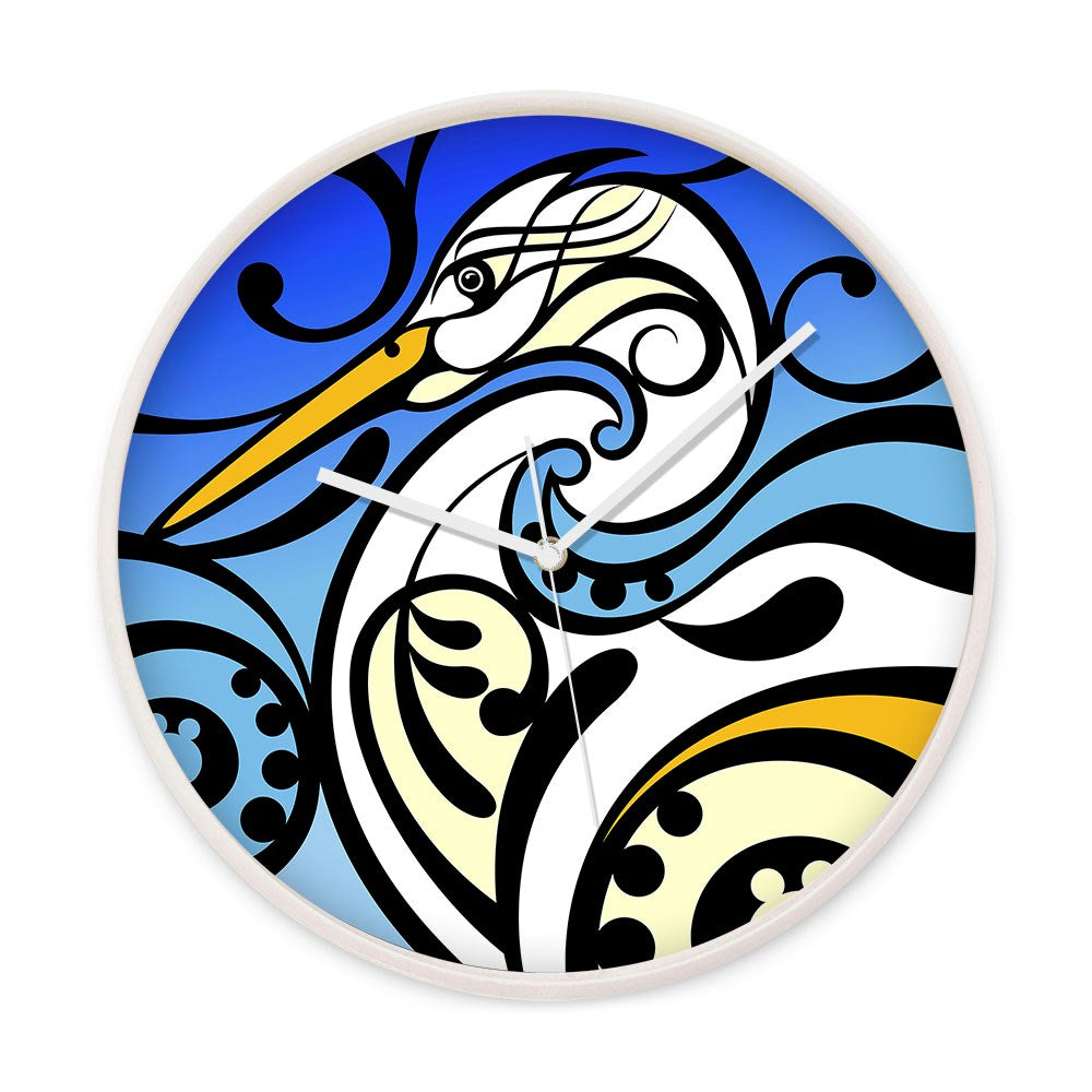 The Shane Hansen - Kotuku Wooden Frame Clock features a stylized heron with flowing black lines and blue gradients, three white hands, no numbers, and silent movement in a round wooden frame.