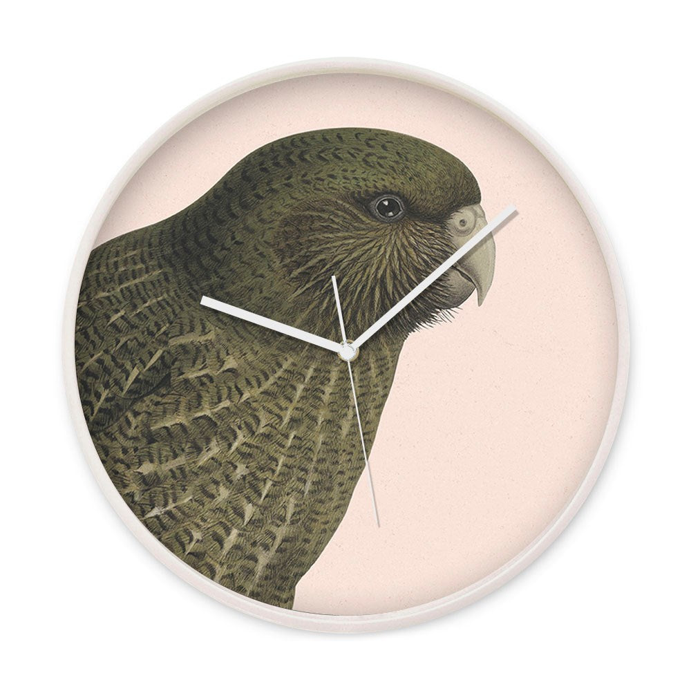 The Hushed Pink Kakapo Wooden Frame Clock showcases a Kakapo illustration covering most of the round face, with silent white hour, minute, and second hands for a peaceful setting.
