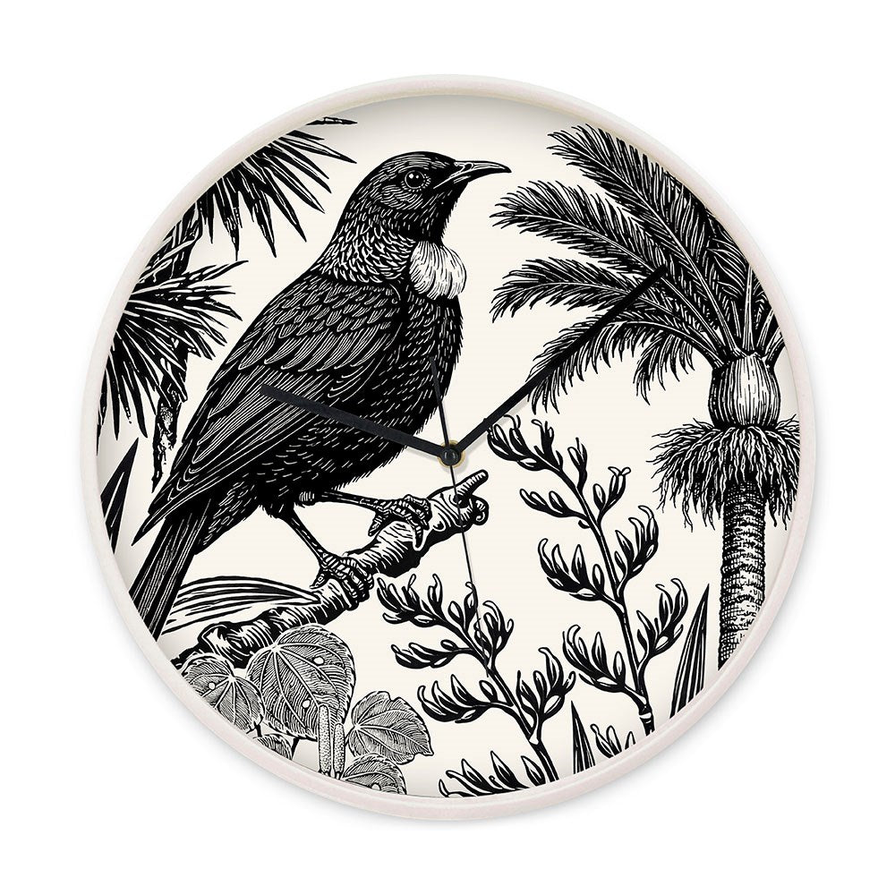 The Under the Nikau Wooden Frame Clock features black hands and a detailed black-and-white illustration of a New Zealand tui on a branch, surrounded by tropical plants and leaves.