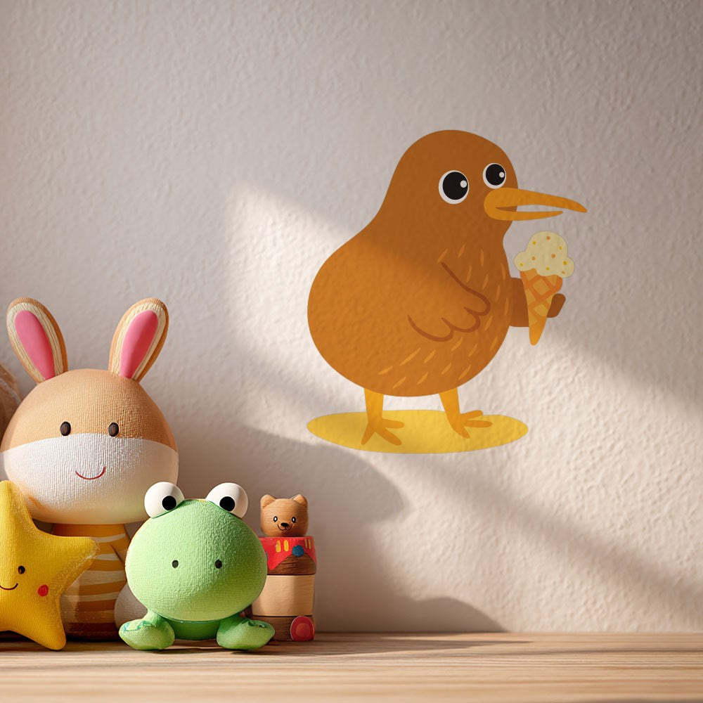 The Kiwi Wall Decal, featuring a cartoon kiwi bird holding an ice cream cone, decorates a light-colored wall above a shelf with stuffed toys—a rabbit, star, green frog, cat, and bear.