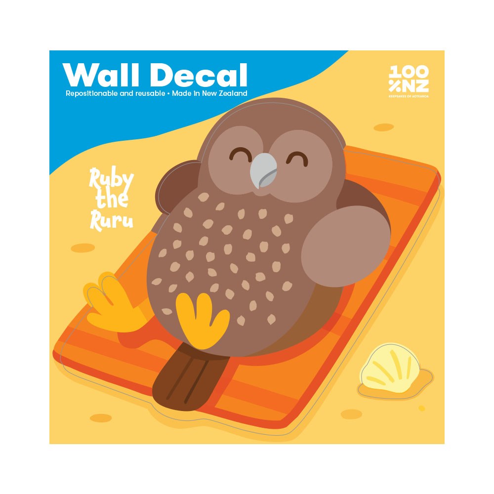 The Ruru Wall Decal features Ruby the brown owl on an orange-striped beach towel with a shell. This peel-and-stick matte fabric wall decal is repositionable, reusable, and made in New Zealand.