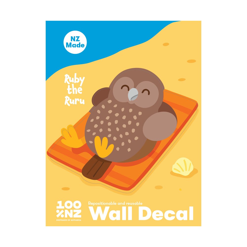 The Ruru Wall Decal features an illustrated brown owl, Ruby the Ruru, lying on an orange beach towel with a seashell nearby. This NZ Made decal offers matte fabric finish and is repositionable—simply peel and stick!.