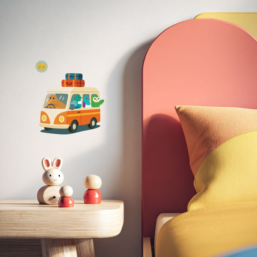 A children’s room with a wooden toy bunny, figures, a colorful pillow on a curved headboard bed, and the Kiwi Road Trip Wall Decal—repositionable wall art featuring cartoon animals in a van with a matte fabric finish.