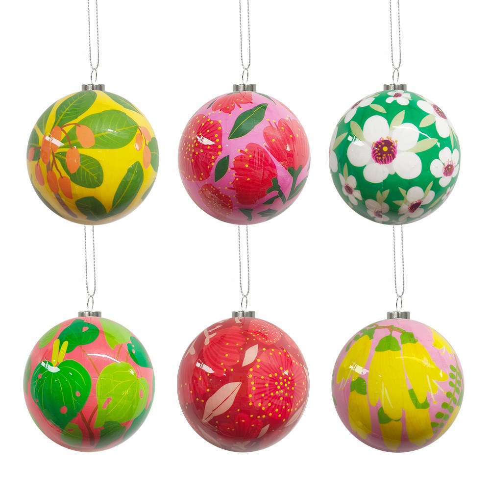 Six round NZ Botanicals Christmas Baubles – Second, featuring shiny surfaces and adorned with vibrant floral patterns in green, yellow, pink, and red inspired by New Zealand botanicals, are arranged in two rows of three on a white background. Each bauble is finished with a silver cap and hanging string—ideal as distinctive Christmas decorations or as part of a festive gift box set.