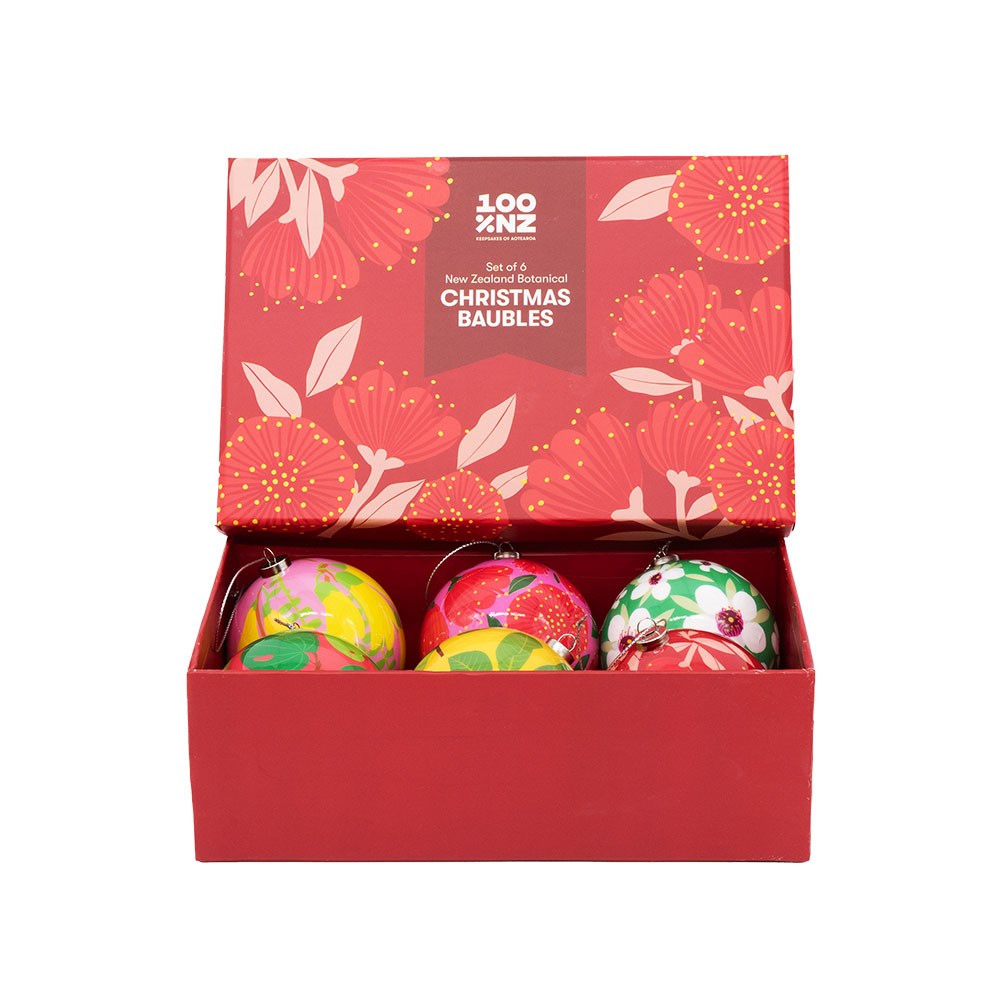 The NZ Botanicals Christmas Baubles - Second is a vibrant red gift box set decorated with a floral pattern and labeled “NZ Set of 4 Botanical CHRISTMAS BAUBLES” in white on the lid. Inside, you’ll find four colorful baubles adorned with festive botanical designs—perfect for adding charming New Zealand flair to your holiday décor.