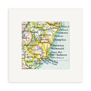 The Dunedin Vintage Map Print is a framed close-up of a vintage lithograph map featuring the southeastern coast of New Zealand, including Dunedin, Port Chalmers, Taieri, and Oamaru.