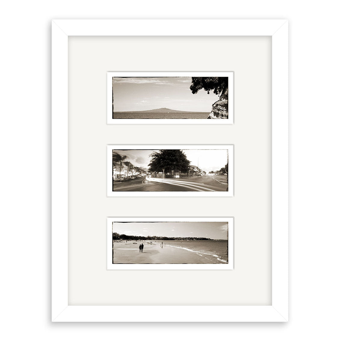 The Takapuna Triptych - RP088 features a white frame with three vertically stacked black-and-white outdoor photos of New Zealand by Reuben Price, each centered on a white mat.