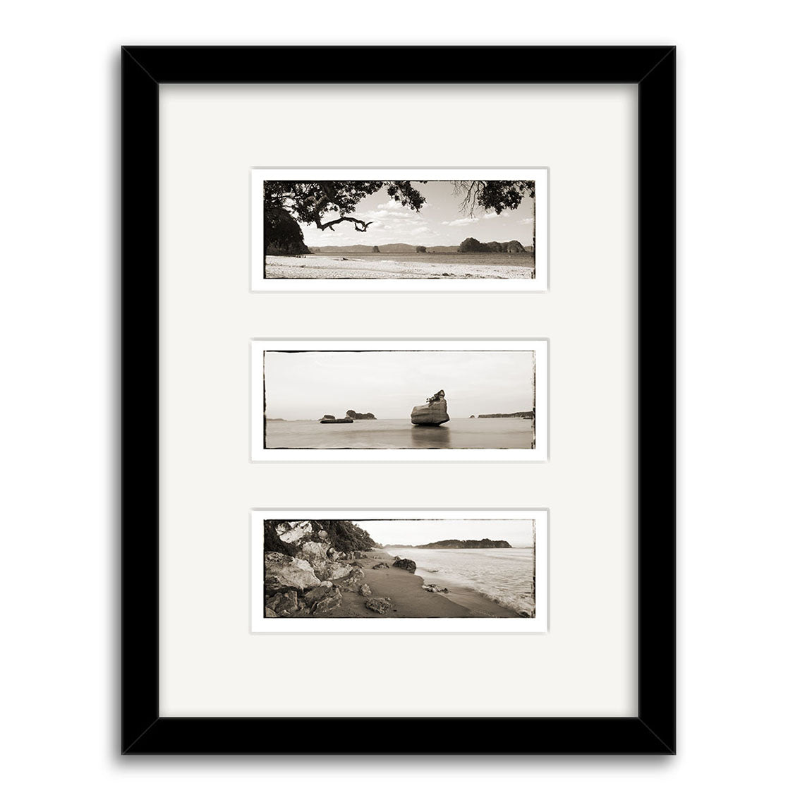 The Coromandel Triptych - RP124 features three black and white coastal New Zealand prints, arranged vertically with rocks, water, and trees, presented with a white mat in a black frame on archival matte paper.