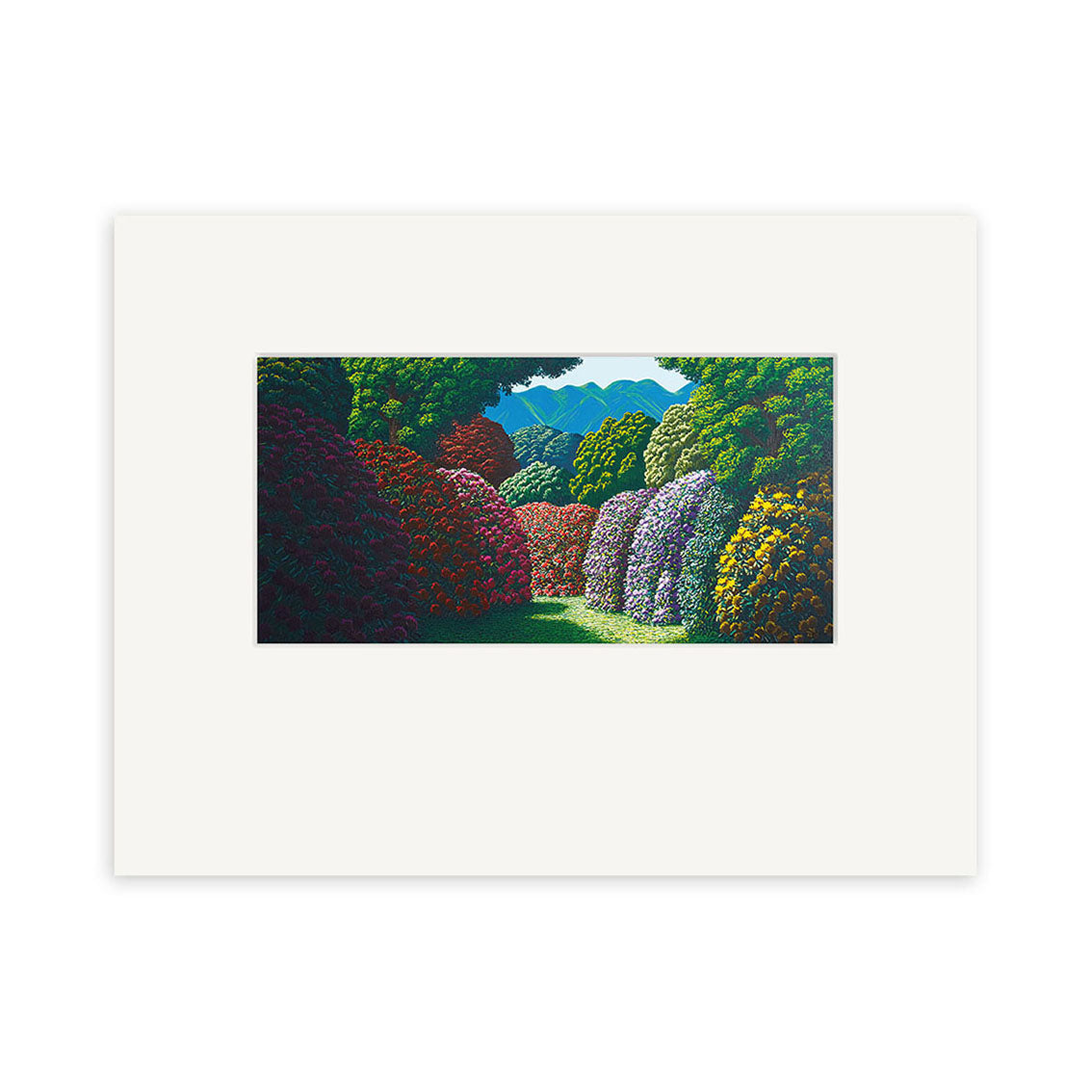 The Karl Maughan - Whenua Tapu Hills Small Art Print showcases vibrant flowering bushes and lush trees along a grassy path leading to blue hills, centered on a white mat—perfect for displaying this New Zealand landscape artwork.