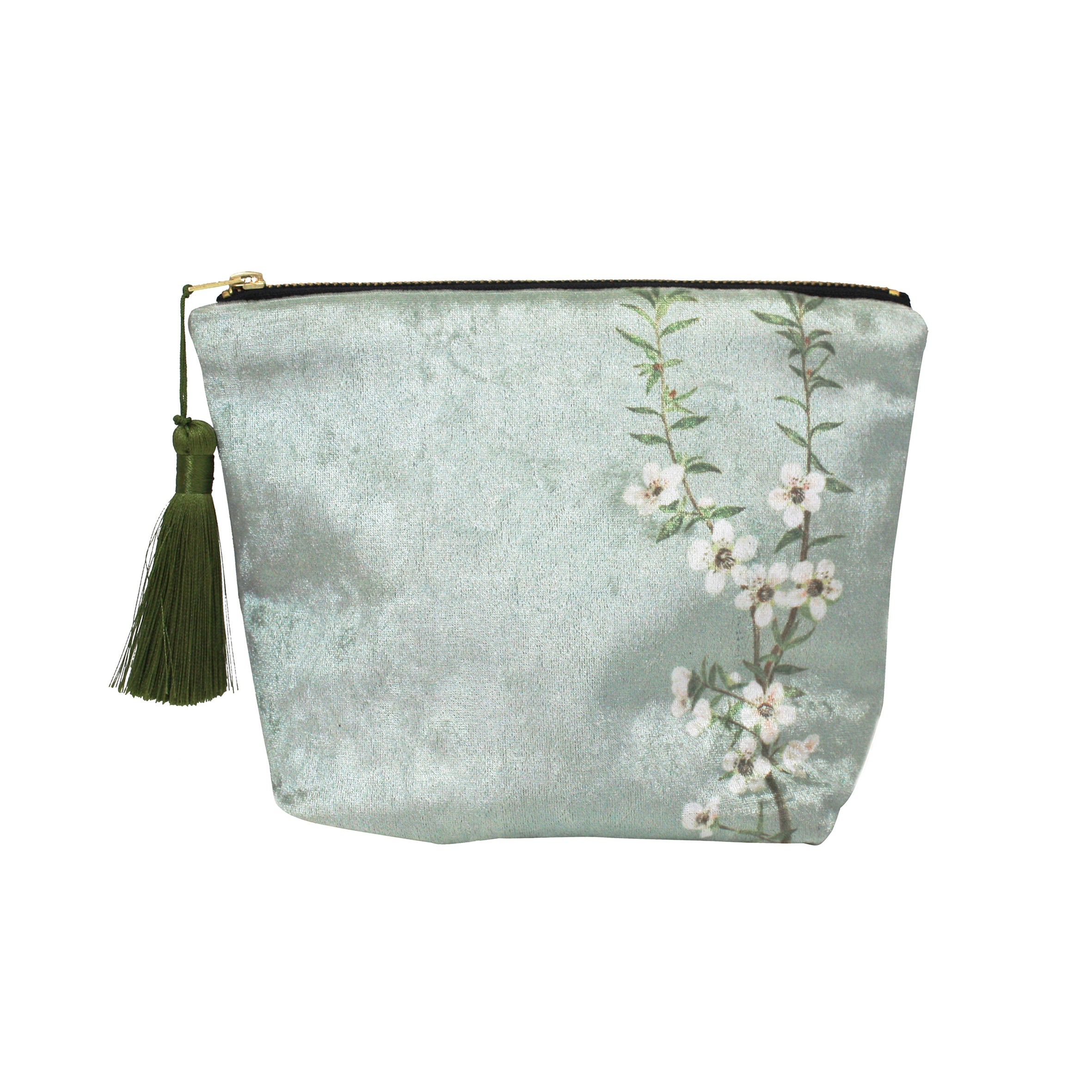 The Vintage Botanical Manuka Velvet Cosmetic Bag features light green velvet, a gold zipper, a green tassel, and white flowers with green leaves inspired by vintage botanicals along one side.