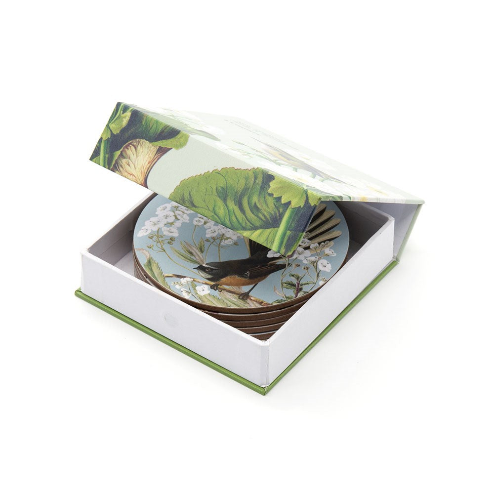 The Birds & Botanicals of NZ Set of 6 Coasters features round coasters with bird and foliage designs, neatly stacked in a matching open decorative box with a hinged lid.
