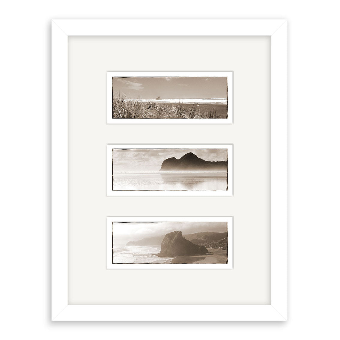 The West Coast Triptych - RP014 features three black-and-white New Zealand coastal landscape prints with mountains, water, and shoreline, arranged vertically in a white frame with a white mat.