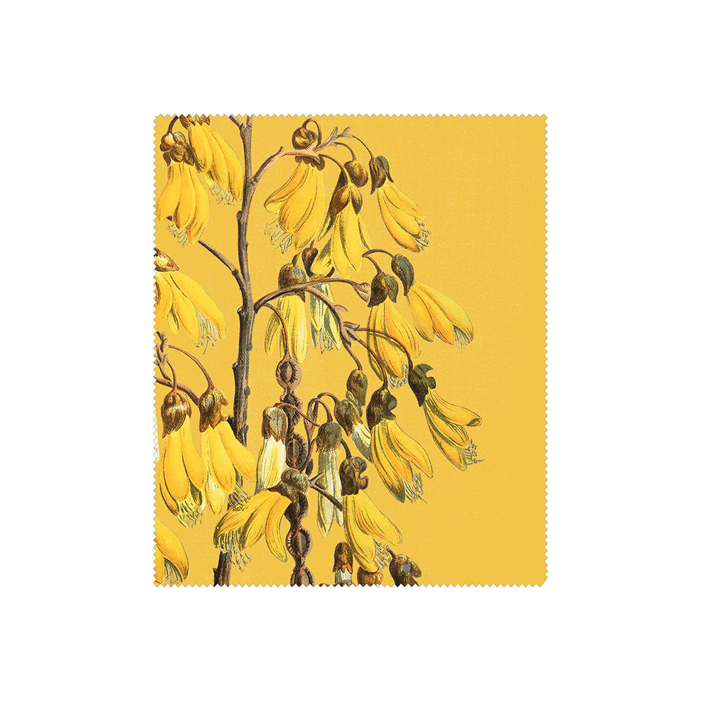 This set of 3 Vintage Botanical Collection Lens Cloths features yellow kowhai flowers on brown stems over a yellow background with zigzag edges. The design is inspired by New Zealand’s native flora.