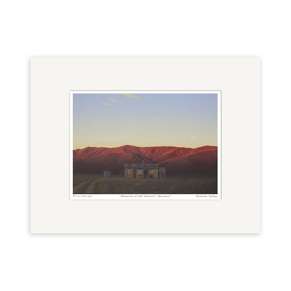 Grahame Sydney - Moonrise at the Shearers Quarters Small Art Print features a glowing house beneath a pale sky and visible moon, set against red mountains at sunset. Matted with a white border, its ideal for display.