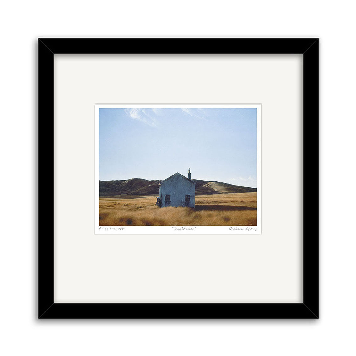The Grahame Sydney - Cookhouse Small Art Print features a solitary white house in a dry grassy field beneath a clear blue sky, presented in a black frame with white mat—echoing the renowned New Zealand artists signature style.