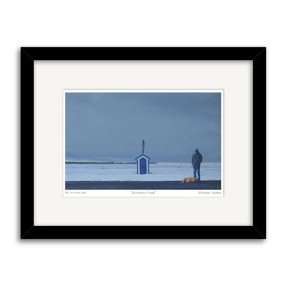 The Grahame Sydney - Irishman Creek Small Art Print depicts a snowy, desolate landscape with a blue and white hut, a figure atop the roof, and another in a hooded coat near a yellow bag under an overcast sky.