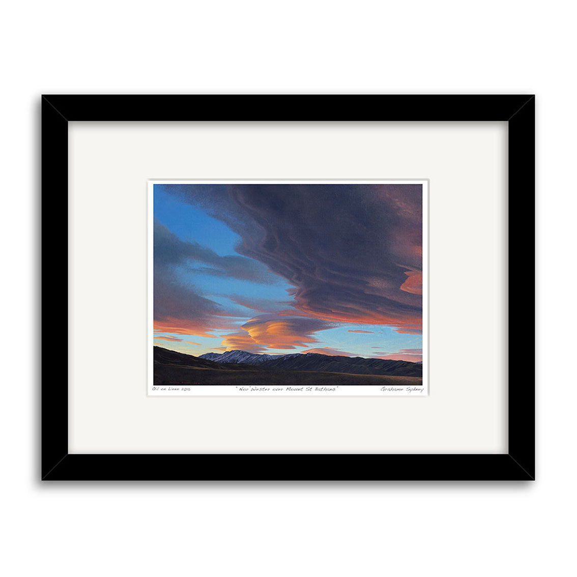 The Grahame Sydney - Norwester over Mt St Bathans Small Art Print features dramatic, swirling sunset clouds over distant mountains in blue, orange, and pink hues, framed in black with white mat—ideal for print collectors.