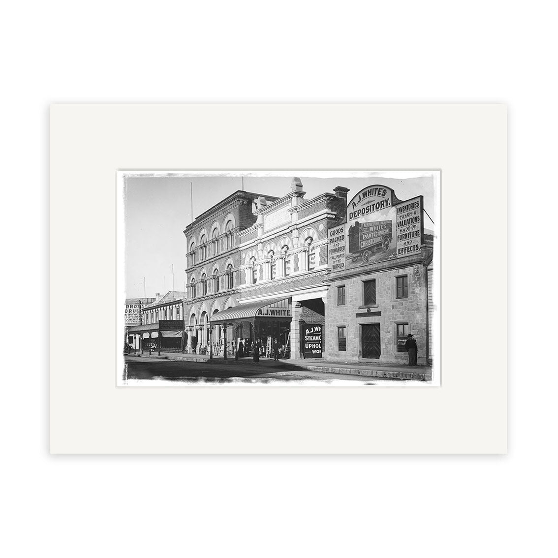 Archival-quality black-and-white photo, Tuam St 1900 - HI030, shows a historic New Zealand street with a three-story brick building, smaller storefront, Whites Depository sign, people near the entrance, and a streetcar to the left.