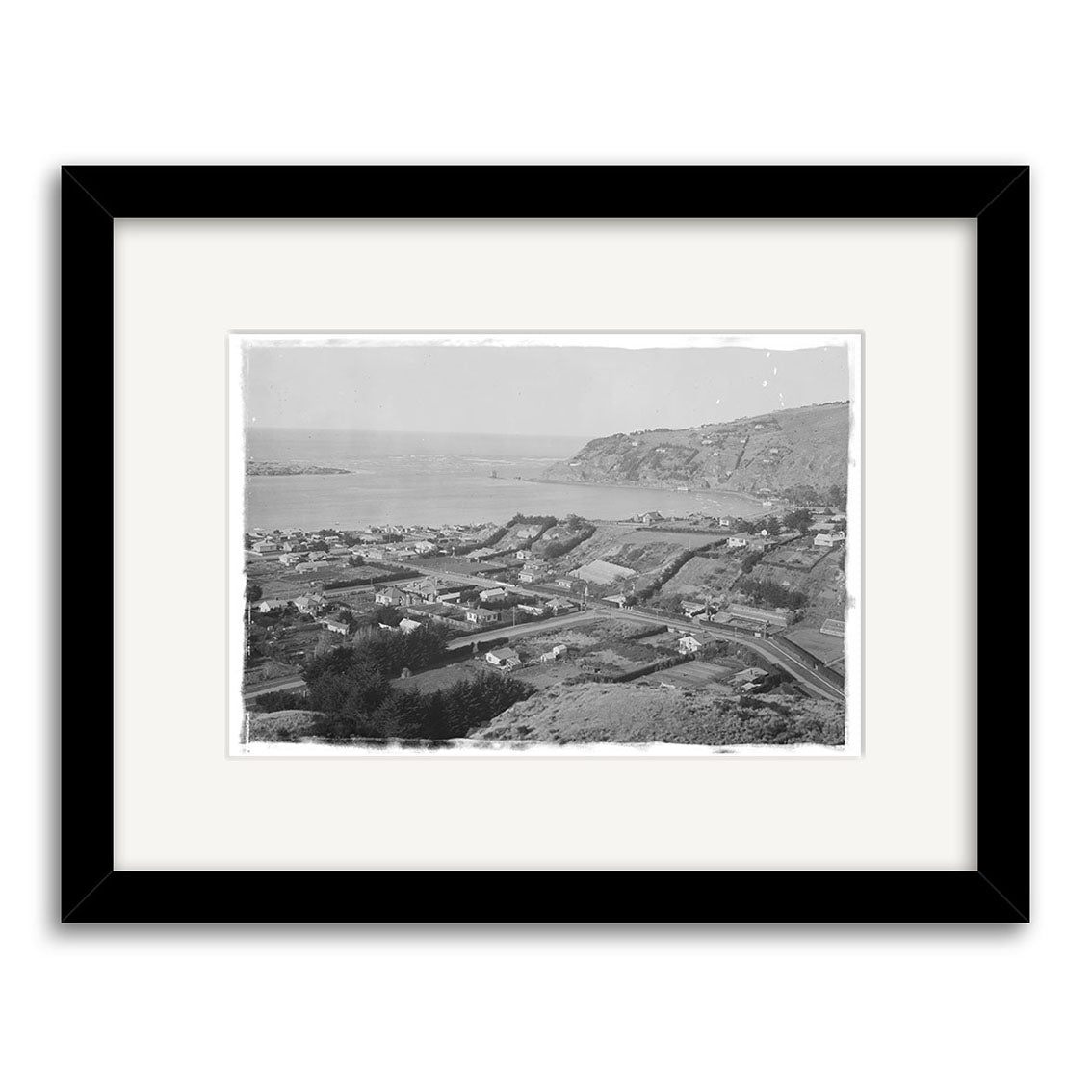 Framed black-and-white Redcliffs 1920 - HI035 Historical Photographic Print of a New Zealand coastal town with houses, roads, and hills, printed on archival-quality matte paper for lasting preservation.