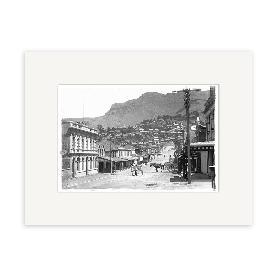 The London St Lyttelton 1916 - HI037 black-and-white historical photographic print shows a street scene with horses, carriages, and lined buildings against hills. Printed on archival quality matte paper.