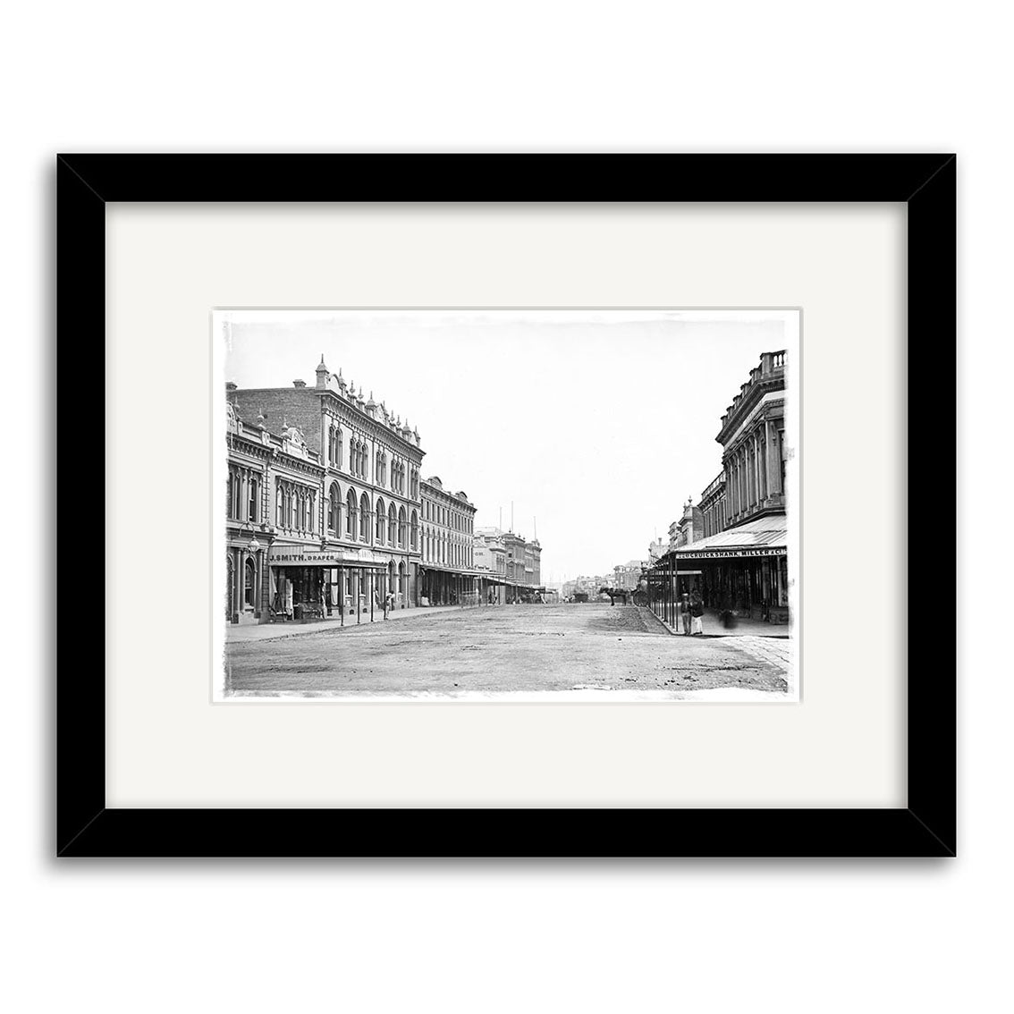 Queen St 1880 - HI040 is a black-and-white historical photographic print of an empty street with ornate, multi-story buildings, presented in archival quality with a white mat and black frame.