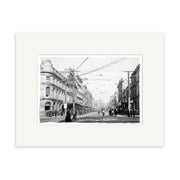 Archival quality black-and-white photo, Queen Street Auckland - HI042, shows a 1904 New Zealand city scene with people, horse-drawn carriages, streetcars beneath wires, and multi-story buildings lining the road.