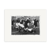 The All Blacks vs Springboks 1937 - HI066 is a black and white historical photographic print capturing players in dark uniforms mid-rugby match, tackling and running on a grassy New Zealand field.