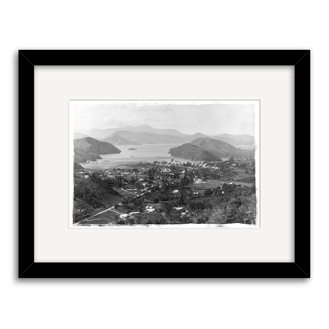 Black-and-white historical photographic print titled Marlborough Sounds 1896 - HI071, depicting a small town by hills and water, presented on archival-quality matte paper with a black-bordered mat.
