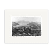 This archival-quality Marlborough Sounds 1896 - HI071 print shows a black-and-white aerial view of a small town with houses, roads, and trees amid hills, water, and distant mountains. Printed on matte paper.