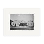 Black-and-white photo of Wanaka Hotel 1870 - HI104, a single-story wooden building in New Zealand, with people out front, horse and carriage on the left, and mountains behind—archival quality matte paper Historical Photographic Print.