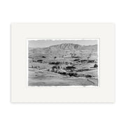 Archival black-and-white photographic print, Arrowtown District 1954 - HI111, shows a rural New Zealand landscape with rolling hills, scattered trees, and distant mountains, presented on a white mat for display quality.