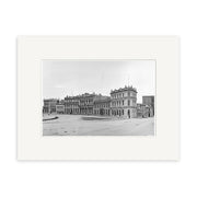 Black and white historical photographic print titled The Cresent 1910 - HI130 shows a large, ornate building with columns on a wide, empty street, highlighting historic New Zealand architecture.