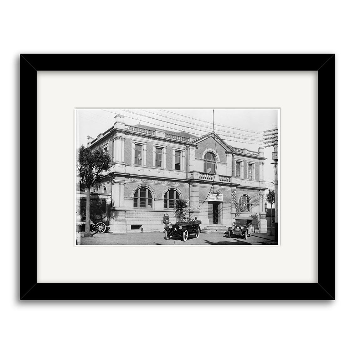 Govt Building 1922 - HI131 is a historical black-and-white photographic print from New Zealand, archivally printed on matte paper, showing a two-story classical POST OFFICE with vintage cars—elegantly framed with white mat and black frame.