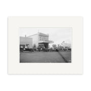 Historic black and white photo of early 20th-century cars by a two-story Photographer building. Broadway Stratford 1919 - HI139 historic New Zealand print available on archival quality matte paper.