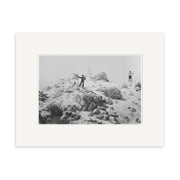 Mt Egmont 1911 - HI143: Black and white photo of two people on a snowy summit in New Zealand, with a wooden triangle structure behind them under an overcast sky. Historical Photographic Print on archival quality matte paper.