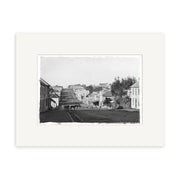 Devon St 1860 - HI146: Black and white historical photographic print of a 19th-century street with houses, horse-drawn cart, and trees. Framed with a white mat on archival-quality matte paper.