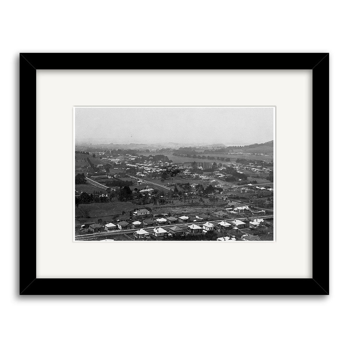 Epsom 1907 No.1 - HI153: Archival black and white photographic print of a New Zealand suburban neighborhood, featuring houses, trees, and roads. Framed with a white mat and black frame for an elevated perspective.