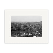 The Epsom 1907 No.1 - HI153 is a black and white aerial photograph of a New Zealand suburb, showing houses, roads, trees, and hills. This historical print is presented in a white mat frame for archival quality display.