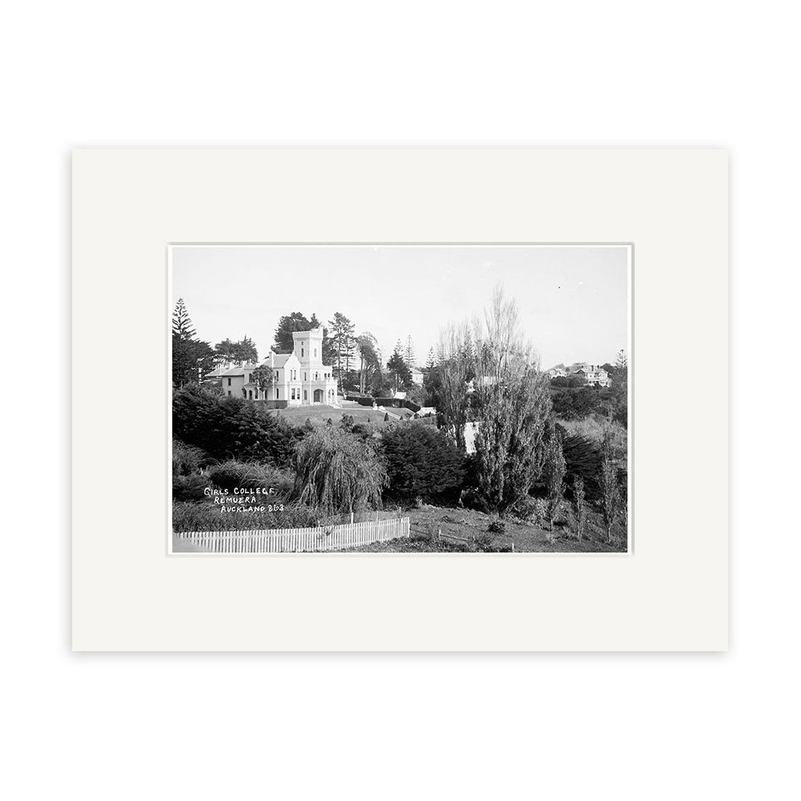Black-and-white archival print titled Girls College 1910 - HI156 shows a large house or institutional building in Remuera, New Zealand, surrounded by trees and wooden fence; handwritten Girls College, Remuera N.Z.