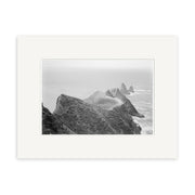 Cape Kidnappers 1880 - HI161: Historical black and white photo of dramatic triangular rock formations in the ocean, seen from above. Printed on archival matte paper, it captures the misty sea and rugged coastline.
