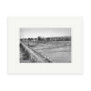 Black and white photo titled Hawkes Bay 1948 - HI166 shows a long wooden aqueduct crossing a barren landscape with distant trees, buildings, and faint mountains. Printed on matte paper for archival quality as a Historical Photographic Print.