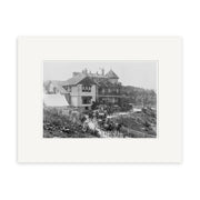 An archival-quality black-and-white photographic print titled Hotel Waitomo 1910 - HI190 shows a large Victorian-style house with a covered porch, horse-drawn carriages, people on the path, and trees and shrubs in the background.