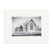 Archival quality Historical Photographic Print of Wesley Methodist Church 1918 – HI202. Black-and-white image shows steep gable roofs, pointed arches, tall windows, spires, and picket fence; print includes a white border.